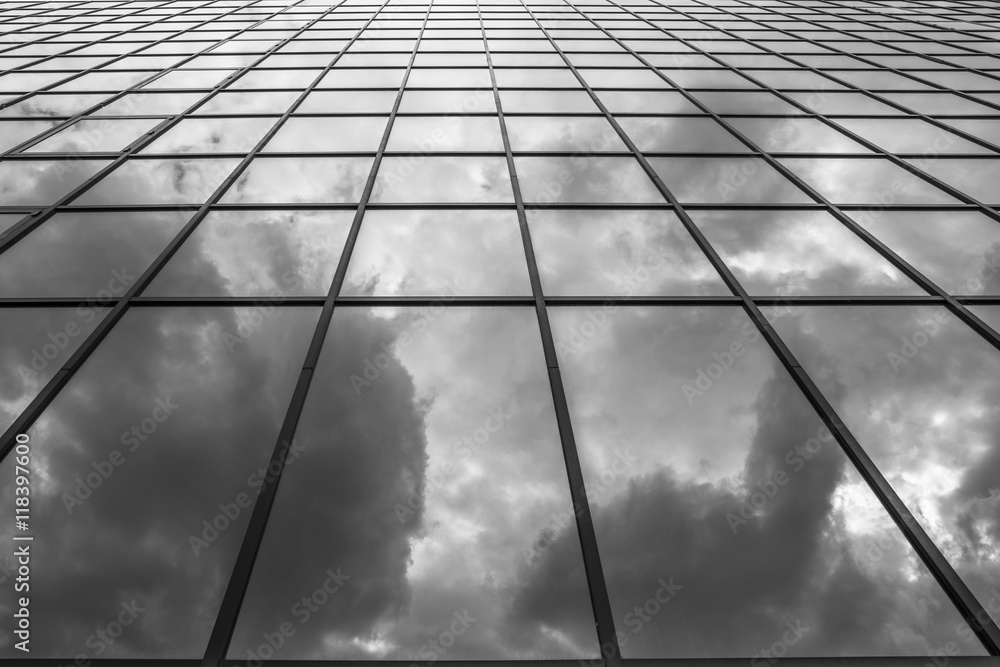 Clouds reflections in a glass building - black and white background Clouds reflections in a glass building - black and white background