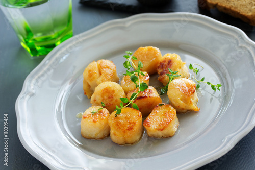 Scallops fried in cream sauce with herbs.