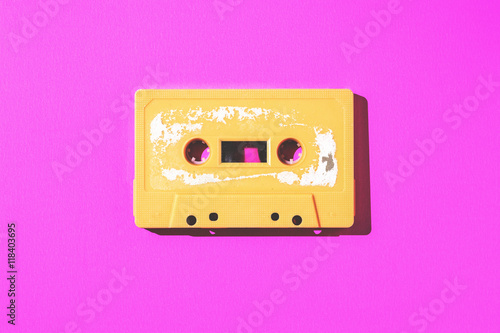 Old cassette tape on pink paper with copy space