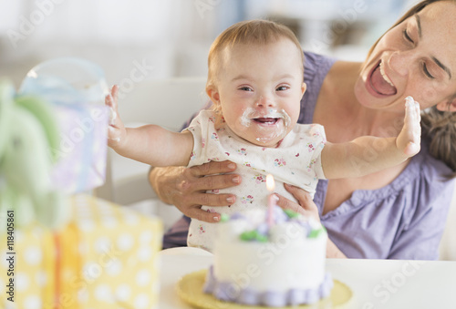 Caucasian mother and baby girl with Down Syndrome celebrating birthday photo