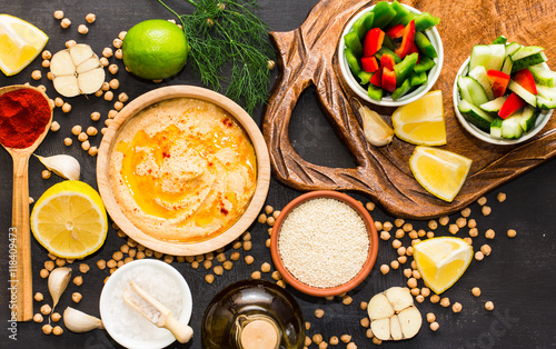 Hummus on a black wooden background