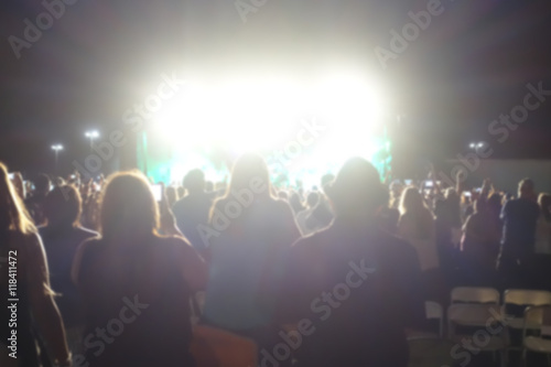 blur background of people at concert with bright lights