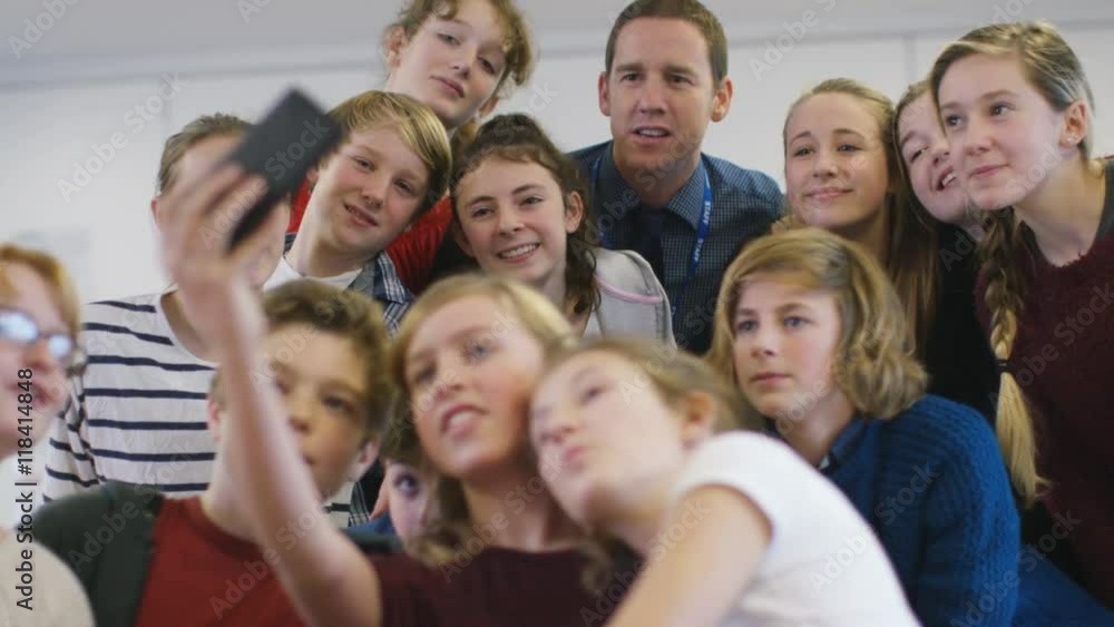 Teacher & students pose for a selfie in school classroom Teacher & students pose for a selfie in school classroom