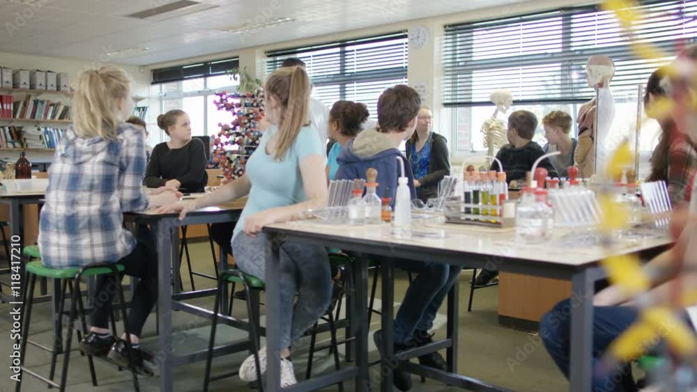 Teacher teaching group of students in school science class Stock Video ...