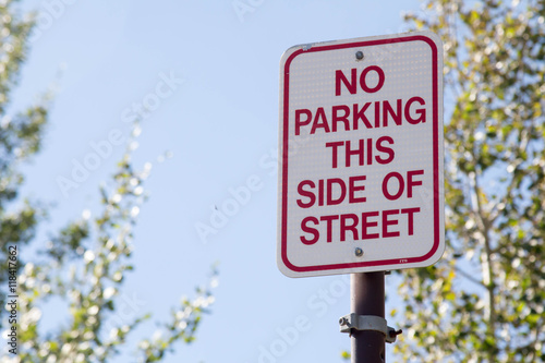 No Parking this side of the street sign