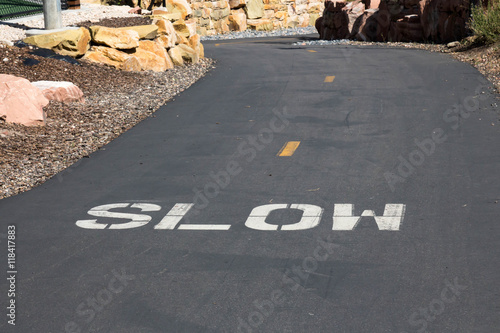 Painted instruction to go slow on a paved bike trail in Park City, Utah