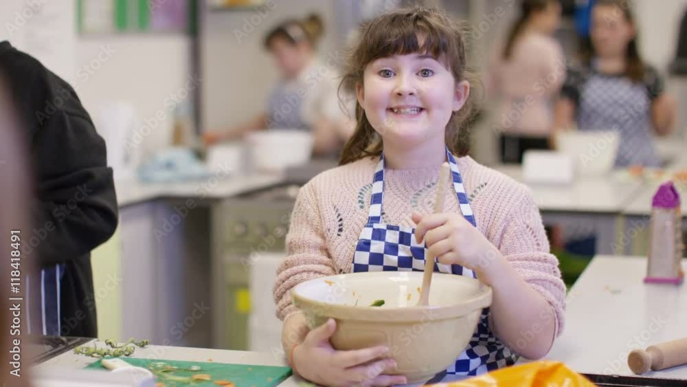 Portrait of happy little girl in school cookery class Portrait of happy little girl in school cookery class
