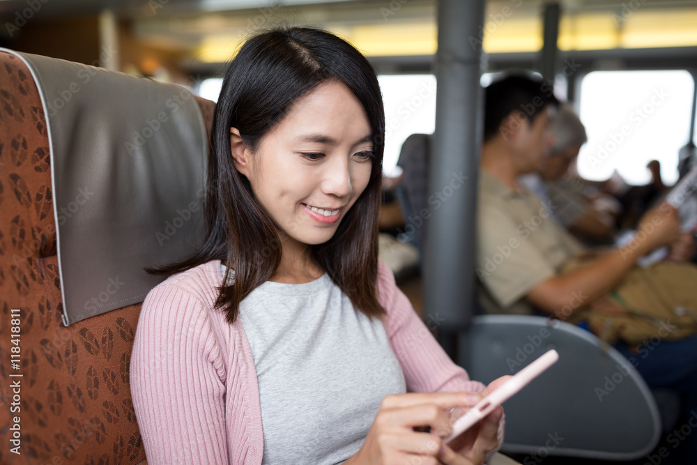 Woman using smart phone inside ship Woman using smart phone inside ship