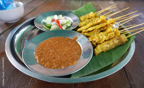 grilled curry pork on the sticks serving with curry peanut sauce