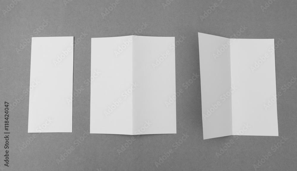 Bifold white template paper on gray background . Bifold white template paper on gray background .