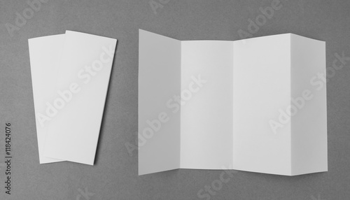 Four - fold white template paper on gray  background . photo