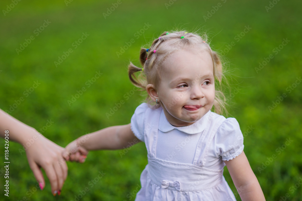 very emotional little girl walks in the summer park very emotional little girl walks in the summer park