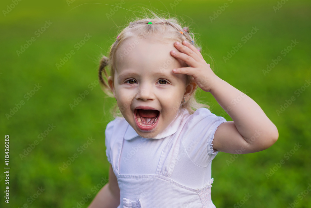 very emotional little girl walks in the summer park very emotional little girl walks in the summer park