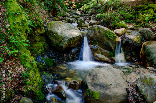 Attractive Waterfall and Green Moss Stone In Forest
