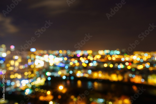 Ho Chi Minh city by night in bokeh abstract background, Vietnam. Ho Chi Minh city (aka Saigon) is the largest city and economic center in Vietnam with population around 10 million people.