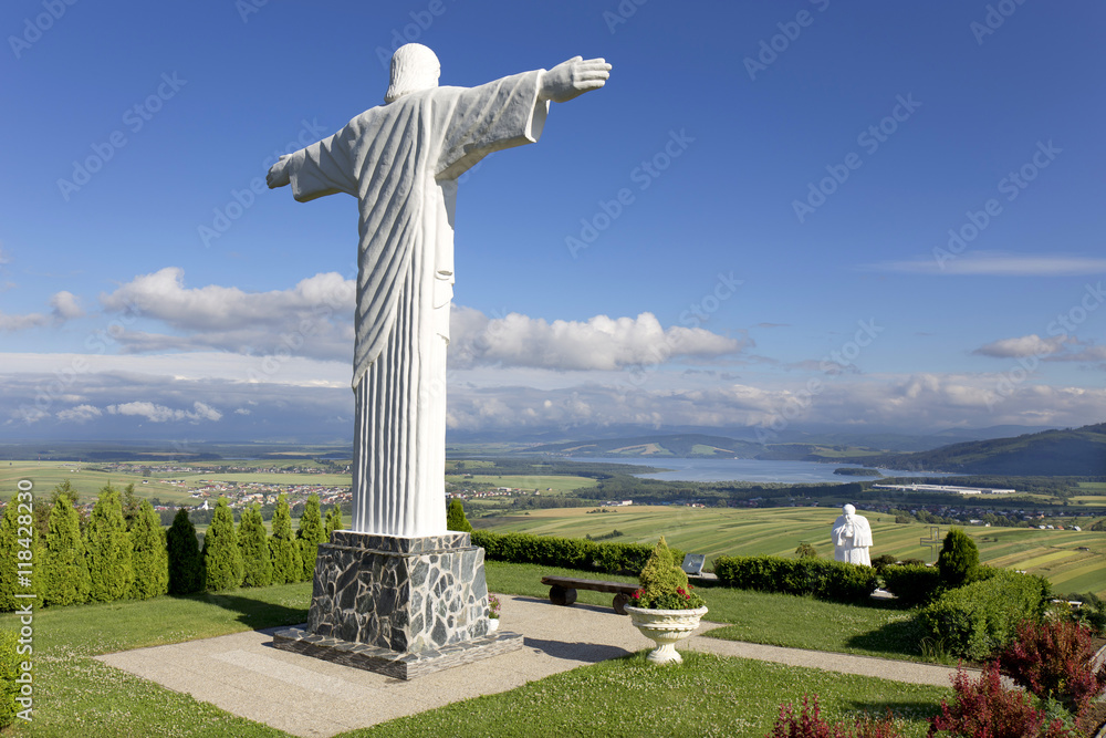 Big white Statue of Jesus over Landscape, Klin, Slovakia