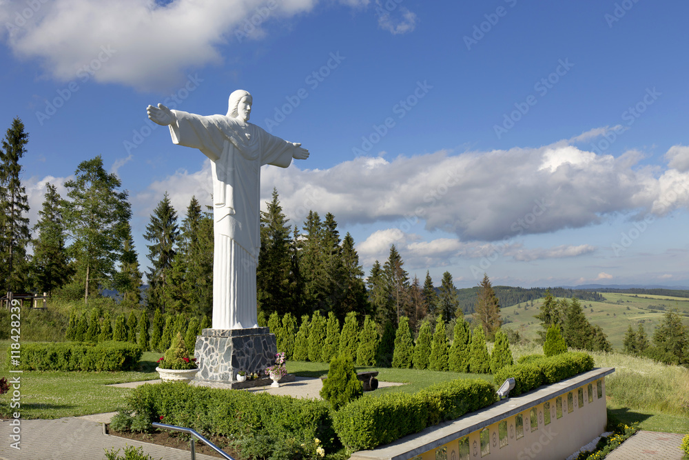 Big white Statue of Jesus over Landscape, Klin, Slovakia