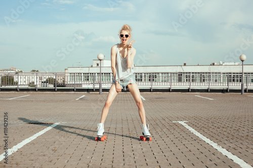 Beautiful teenage girl rollerskating in city