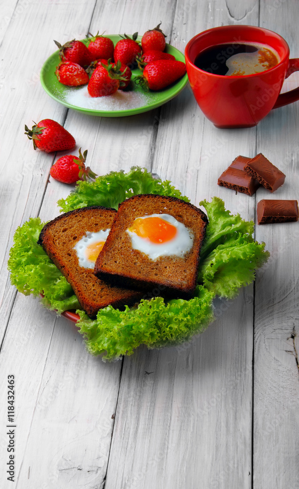 two fried eggs in toast on the salad, cup of coffe stars to two fried eggs in toast on the salad, cup of coffe stars to