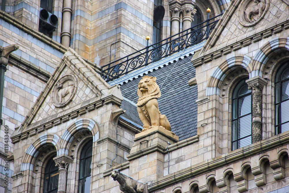Sculpture of lion on Natural History Museum in London- building and details.