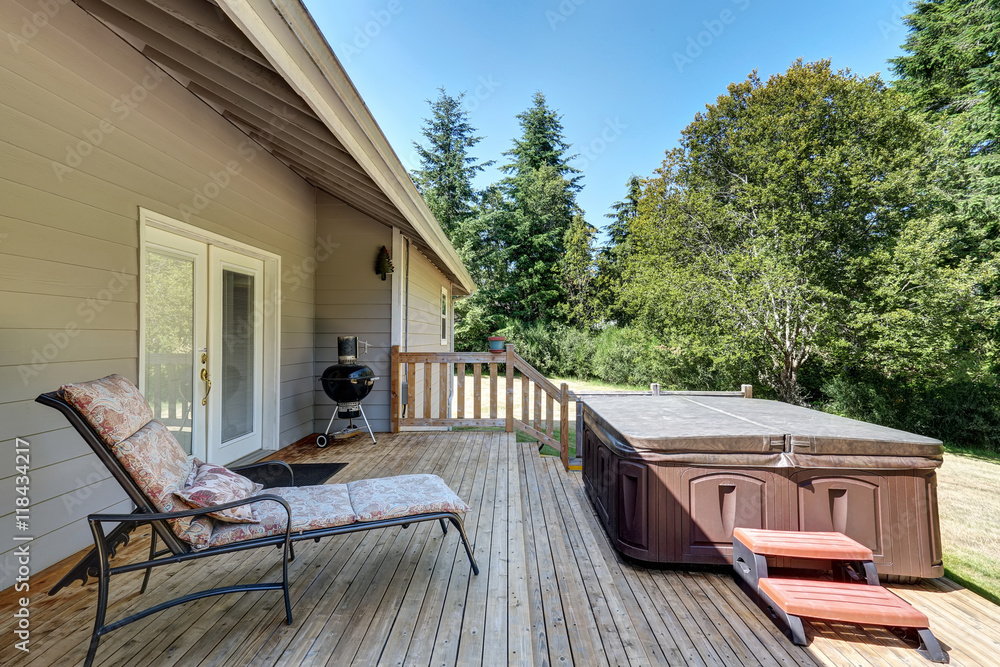 Backyard house exterior with patio area and hot tub on the walkout deck. - obrazy, fototapety, plakaty 