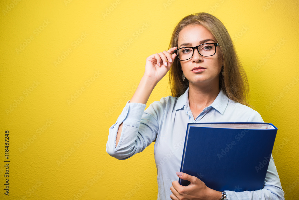 Cute business woman in spectacles holding a folder Cute business woman in spectacles holding a folder