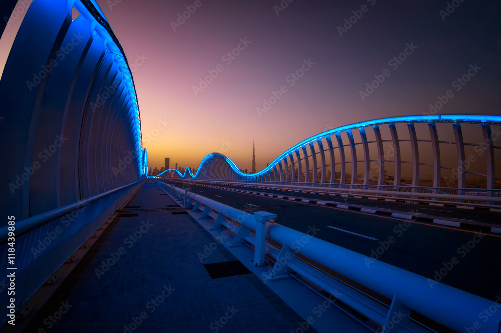 Fototapeta premium Amazing night VIP bridge during beautiful sunset. Private road to Meydan race course, Dubai, United Arab Emirates