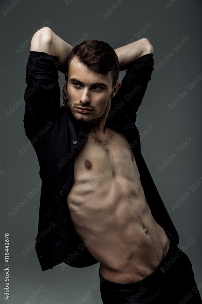 sexy young fashion man wearing a black shirt unbuttoned sexy young fashion man wearing a black shirt unbuttoned