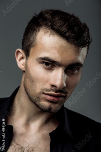 sexy young fashion man wearing a black shirt unbuttoned © smmartynenko