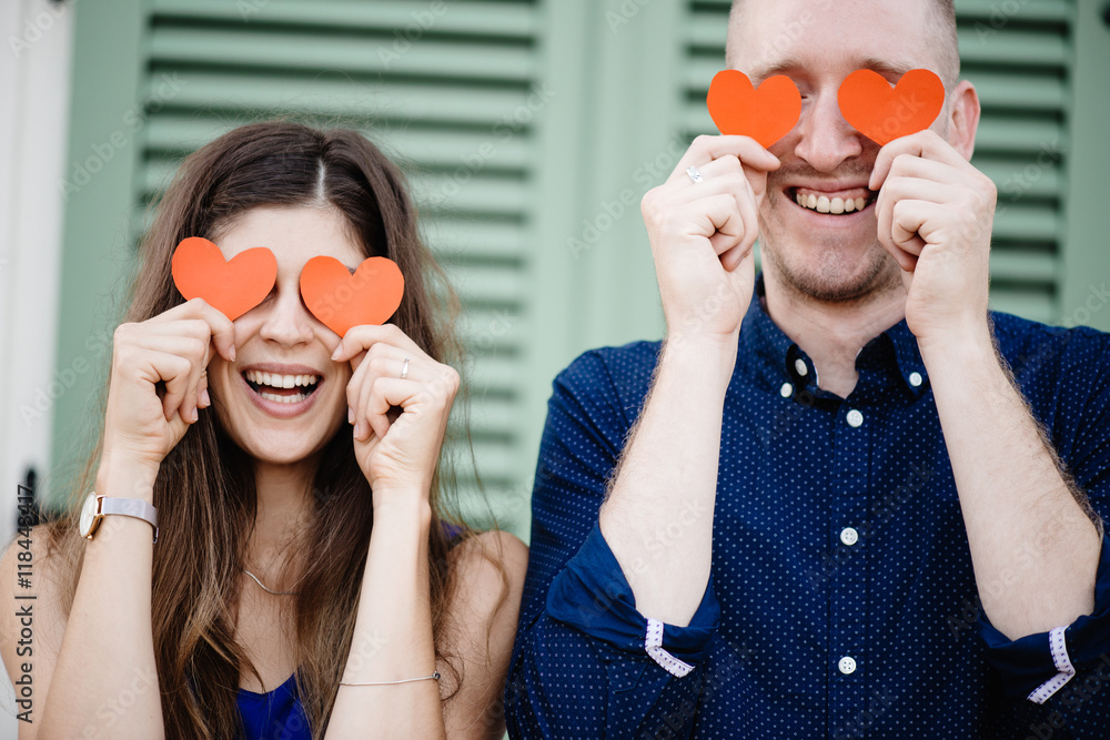 Young couple holding hearts, love concept - obrazy, fototapety, plakaty 