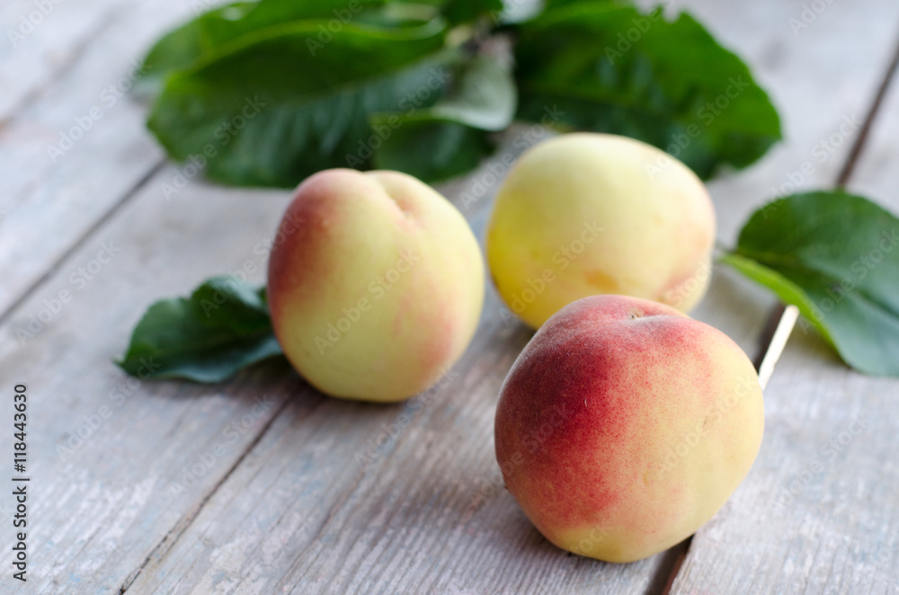 Ripe peaches on a gray wooden table Ripe peaches on a gray wooden table