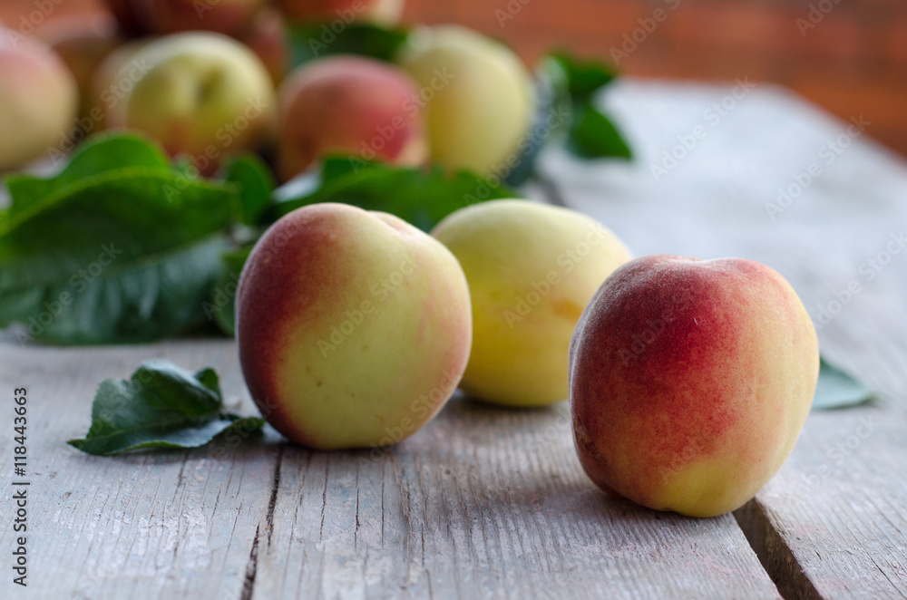 Ripe peaches on a gray wooden table Ripe peaches on a gray wooden table
