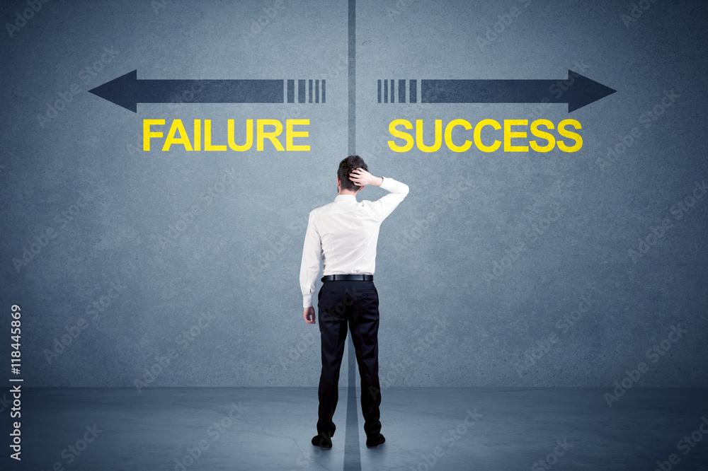 Fototapeta premium Businessman standing in front of success and failure arrow conce