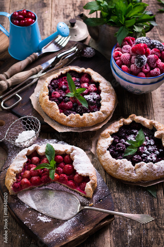 Blueberry,cherry,raspberry and blackcurrant galette on w wooden background.