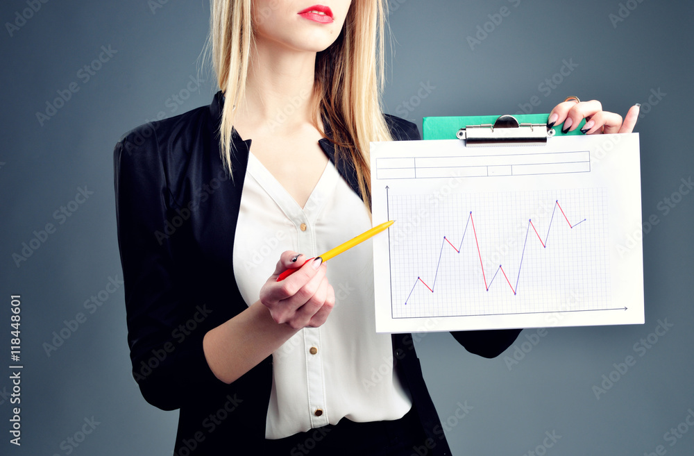 business, finances and economics - businesswoman drawing charts in the air