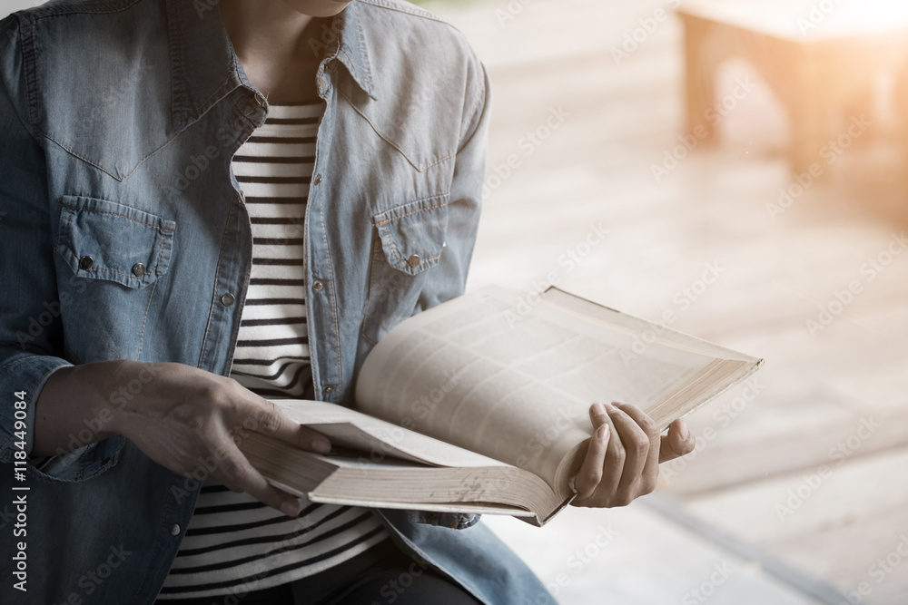 Fototapeta premium vintage photo of woman reading text book in library.
