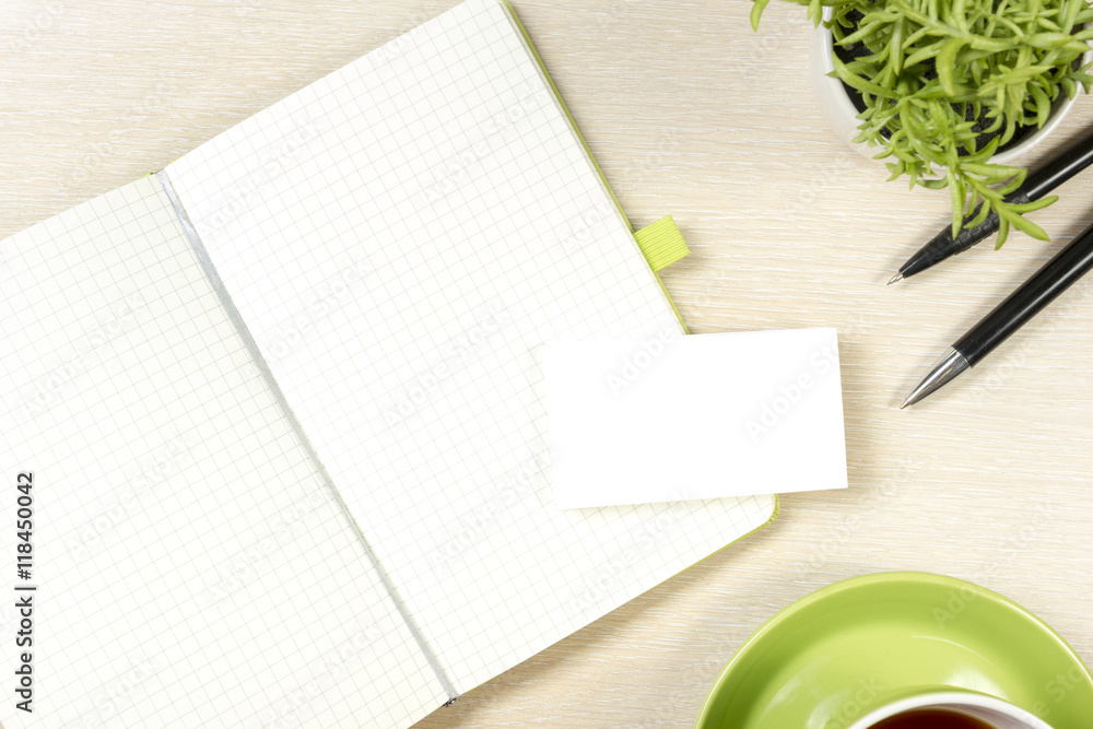 Business card blank, notepad, coffee cup and pen, flower at office desk table top view. Corporate stationery branding mock-up Business card blank, notepad, coffee cup and pen, flower at office desk table top view. Corporate stationery branding mock-up