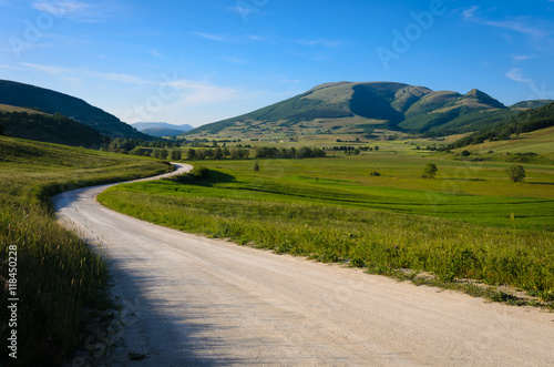A mountain road with the Mount Pennino in the background