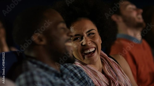  Couple watching a film in crowded movie theatre