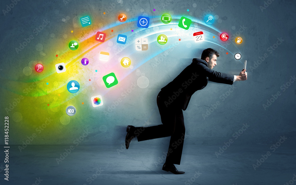Running businessman with application icons from device Running businessman with application icons from device