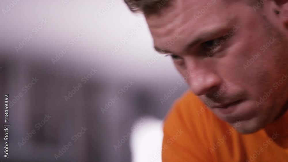 Close up of man working out on exercise bike at the gym Close up of man working out on exercise bike at the gym