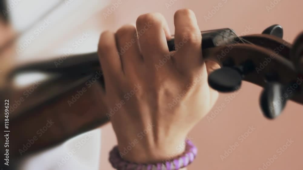 child plays on a violin. close-up child plays on a violin. close-up