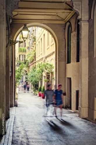 people walking along beautiful narrow european street
