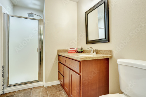 Bathroom interior with vanity cabinet and granite counter top.