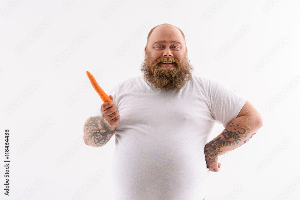 Man holding a carrot Stock Photo | Adobe Stock