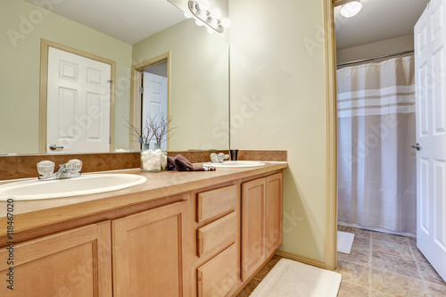 Bathroom interior with vanity and white shower curtain.