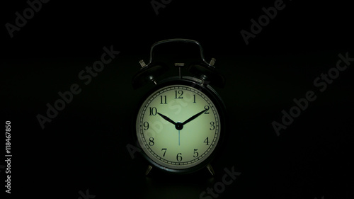 Time is up - alarm clock isolated on black background