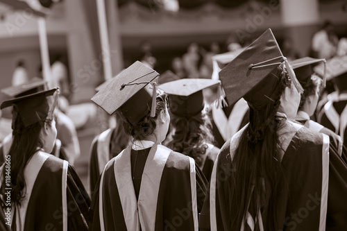 Graduates are stand up in line to get your degree ,sepia tone.