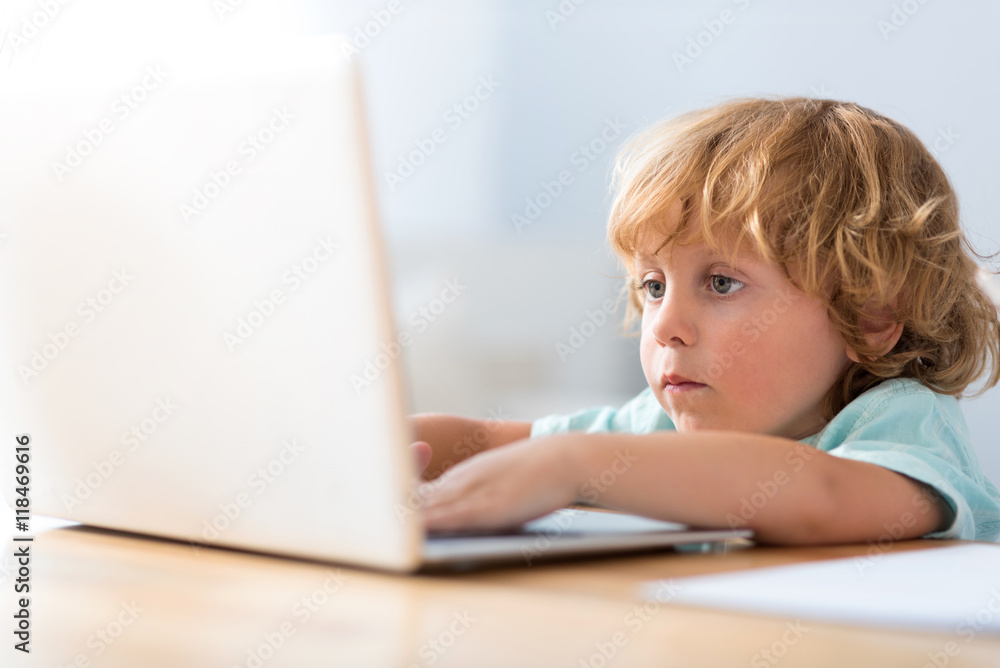 Close up of boy using laptop