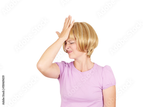 Witless young woman holding her hand to her forehead photo